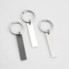 Technical dimensions of a flat rectangle metal bar keychain showing 45mm by 10mm pendant and 28mm key ring size for B2B supplier catalog.Can be used for laser engraving custom text.