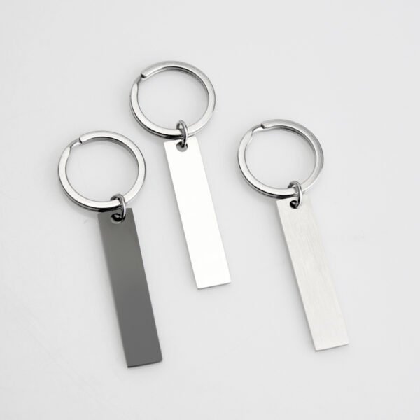 Technical dimensions of a flat rectangle metal bar keychain showing 45mm by 10mm pendant and 28mm key ring size for B2B supplier catalog.Can be used for laser engraving custom text.