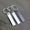 Technical dimensions of a flat rectangle metal bar keychain showing 45mm by 10mm pendant and 28mm key ring size for B2B supplier catalog.Can be used for laser engraving custom text.