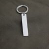 Technical dimensions of a flat rectangle metal bar keychain showing 45mm by 10mm pendant and 28mm key ring size for B2B supplier catalog.Can be used for laser engraving custom text.