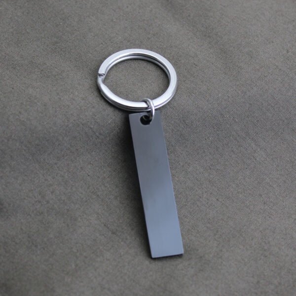 Technical dimensions of a flat rectangle metal bar keychain showing 45mm by 10mm pendant and 28mm key ring size for B2B supplier catalog.Can be used for laser engraving custom text.