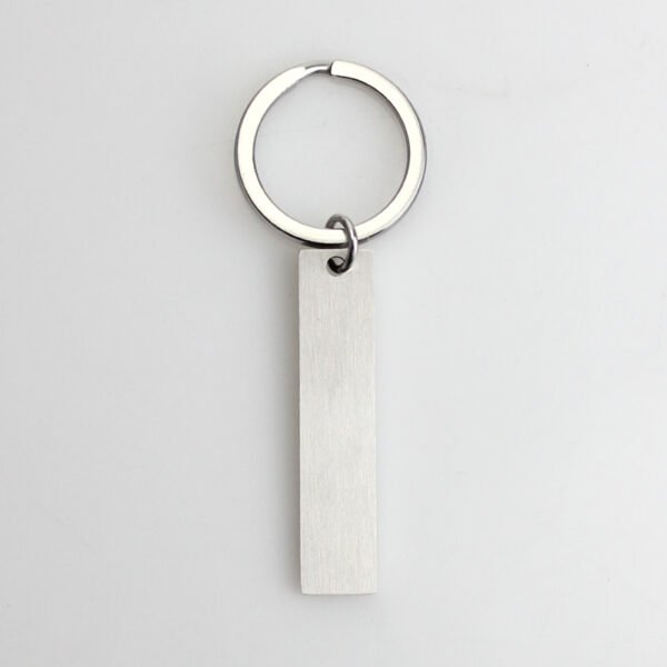 Technical dimensions of a flat rectangle metal bar keychain showing 45mm by 10mm pendant and 28mm key ring size for B2B supplier catalog.Can be used for laser engraving custom text.