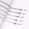 Multi-size finished stainless steel O-chains showing precision wire diameters from 0.4mm to 1.0mm with lobster clasps for B2B catalog.