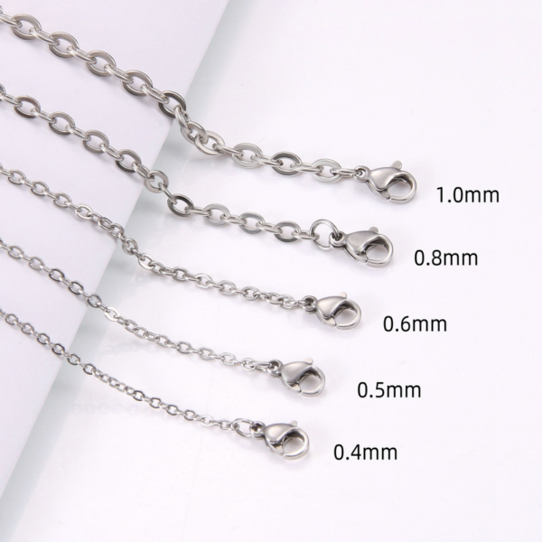 Multi-size finished stainless steel O-chains showing precision wire diameters from 0.4mm to 1.0mm with lobster clasps for B2B catalog.