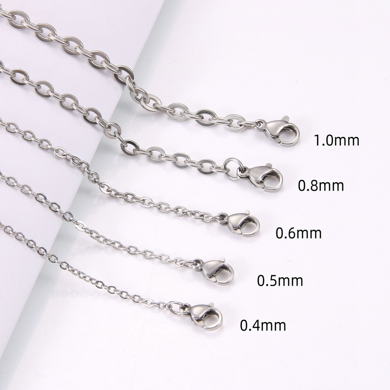 Multi-size finished stainless steel O-chains showing precision wire diameters from 0.4mm to 1.0mm with lobster clasps for B2B catalog.