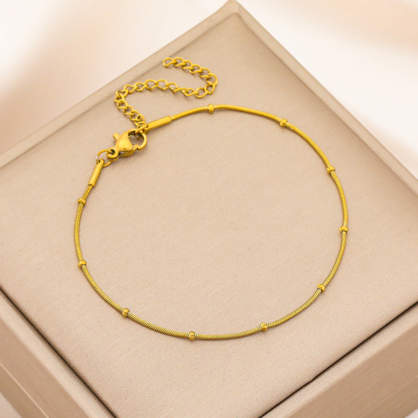 ~[)J{AQ}JEMTBB85`[@5( A finished 18K gold plated stainless steel beaded satellite snake chain bracelet with a sturdy lobster clasp and adjustable link extension chain.