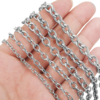 Wholesale bulk stainless steel cable link chains of different widths held in a hand for jewelry making and necklace DIY supplies.