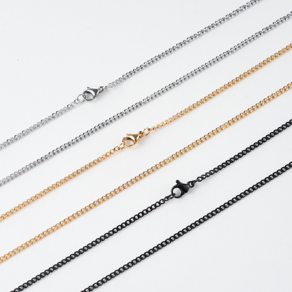 Parallel layout of silver, gold, and black stainless steel Cuban link chains highlighting matching lobster clasps and smooth end rings for wholesale catalog.