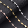 Macro close-up view of silver, gold, and rose gold stainless steel flatted lip chains showcasing the high-polish compressed facets.