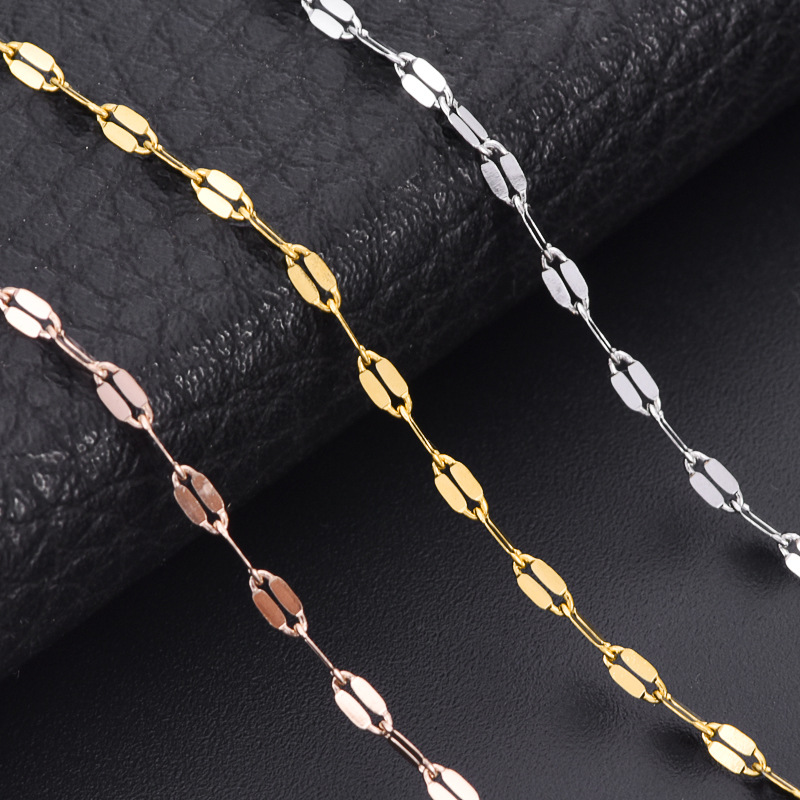 Macro close-up view of silver, gold, and rose gold stainless steel flatted lip chains showcasing the high-polish compressed facets.