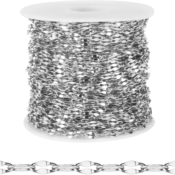 Wholesale bulk silver stainless steel lip chain roll showing the flatted cable link detail on a white spool for jewelry making catalog.