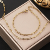回型链 (7) Gold-tone stainless steel paperclip chain bracelet and necklace set displayed in a jewelry box.