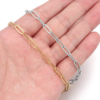 回型链 (9) Gold and silver stainless steel paperclip chain bracelets held in a hand to showcase the high-polish finish for bulk jewelry sourcing.
