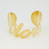 大字母手镯_0003_图层 4 Front view of a wholesale personalized gold stainless steel cursive letter cuff bracelet on a white clean backdrop.