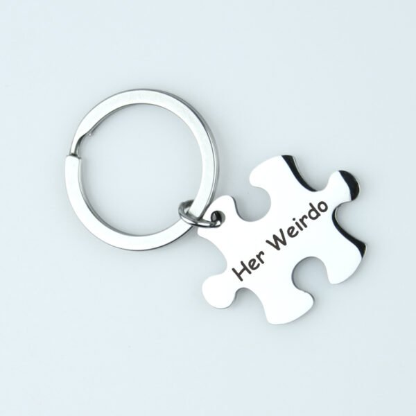 拼图钥匙扣 (2) A finished silver metal puzzle bar keychain with custom text "Her Weirdo" laid flat on a clean white backdrop for B2B catalog.