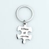 拼图钥匙扣 (20) An isolated view of a single blank stainless steel puzzle piece keychain custom engraved with "A Piece of Her" and a small heart icon.