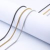 Steel-tone, gold-tone, and black box chains featuring lobster clasps are displayed in a straight line against a white background, allowing B2B buyers to compare the options and examine the details.