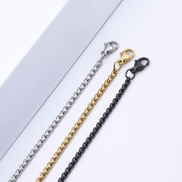Steel-tone, gold-tone, and black box chains featuring lobster clasps are displayed in a straight line against a white background, allowing B2B buyers to compare the options and examine the details.