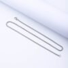 A sleek, steel-colored stainless steel box chain necklace with a lobster clasp, displayed laid flat against a clean white background.
