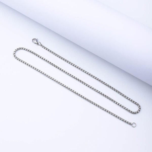 A sleek, steel-colored stainless steel box chain necklace with a lobster clasp, displayed laid flat against a clean white background.