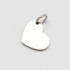 16×12偏孔小心形_0002_图层 5 A blank finished silver stainless steel heart pendant with a secure connection ring laid flat on a clean white backdrop for B2B shop.