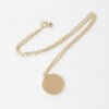 20圆牌和十字链 07 A finished 18K gold plated stainless steel circular identity tag chain necklace with a secure lobster clasp flatly laid on a clean backdrop.