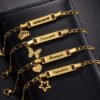 儿童刻字手链 (4) Wholesale custom gold stainless steel kids ID bracelets engraved with names Shikemi, Oluwatobi, Monique, and Signature with matching heart and star charms.