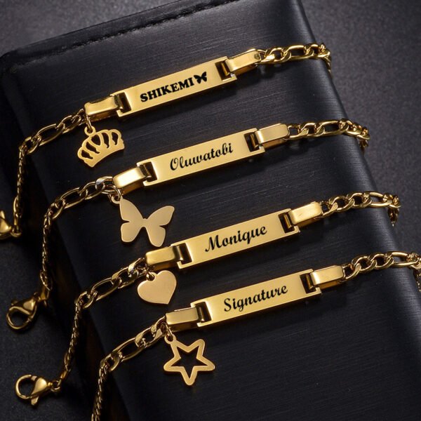 儿童刻字手链 (4) Wholesale custom gold stainless steel kids ID bracelets engraved with names Shikemi, Oluwatobi, Monique, and Signature with matching heart and star charms.