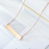 双孔吊坠项链32×6 (2) A blank finished rose gold plated stainless steel horizontal rectangle bar pendant necklace with a lobster clasp displayed flat on a clean background.