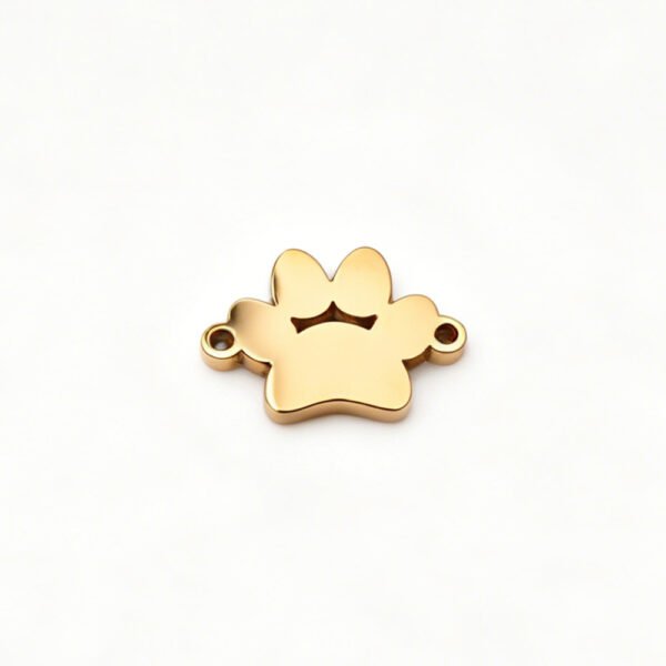 A single blank mirror polished 18K gold plated stainless steel paw print bracelet link connector flatly laid on a clean white backdrop.