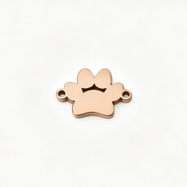 A finished rose gold plated stainless steel 2-hole paw pattern charm connector component flatly laid out on a clean white background for B2B shop.