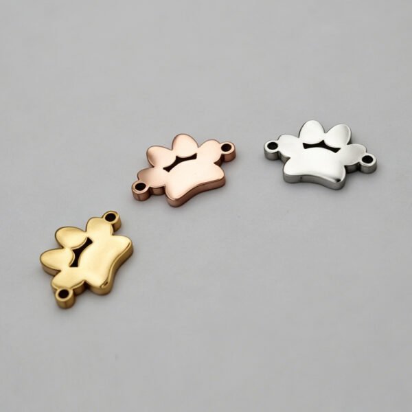 Wholesale blank 2-hole animal paw print link charms in gold, rose gold, and silver finishes arranged in a curve layout for jewelry making catalog.