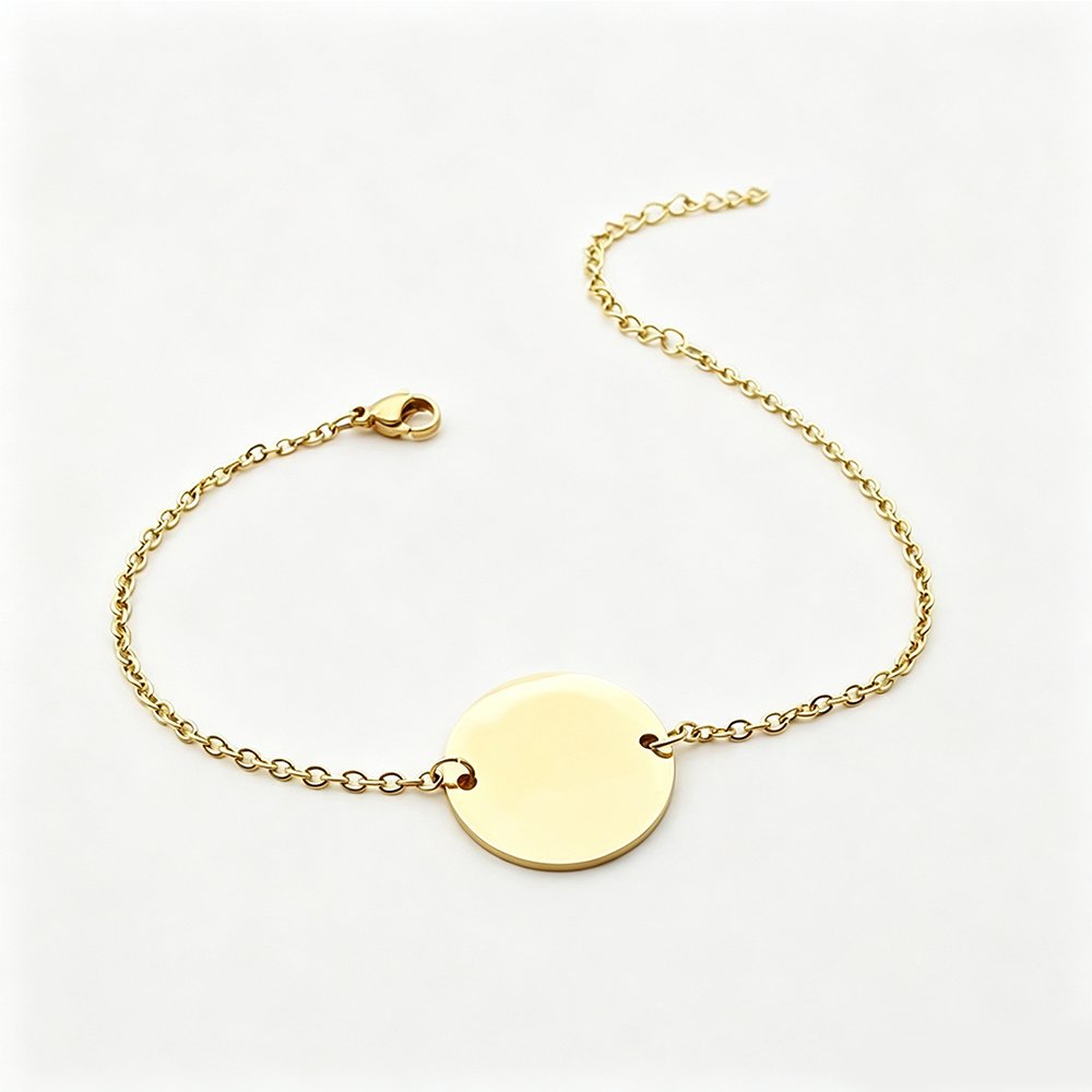 An isolated front view of a finished 18K gold plated stainless steel round disc ID bracelet with an adjustable extension chain on a white background.