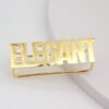 Front view of a wholesale customizable gold stainless steel bold letter statement ring for international boutique jewelry business.