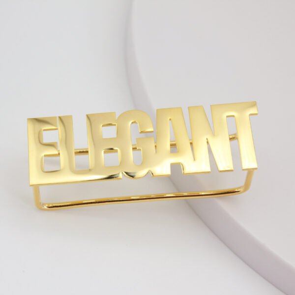 Front view of a wholesale customizable gold stainless steel bold letter statement ring for international boutique jewelry business.
