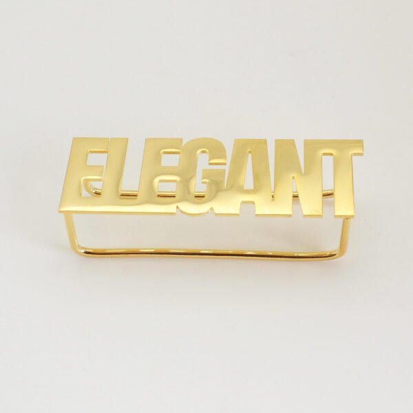 A finished 18K gold plated stainless steel two-finger ring custom laser-cut with the text "ELEGANT" displayed flat on a clean background for B2B catalog.