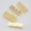 Four personalized gold plated stainless steel multi-finger rings featuring custom names like "Elegant", "Malaje", "Katty", and "Jumorkeh" for wholesale sourcing.
