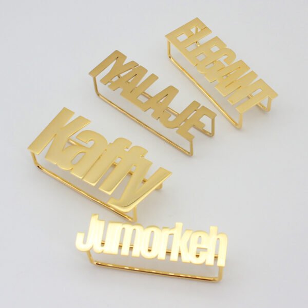 Four personalized gold plated stainless steel multi-finger rings featuring custom names like "Elegant", "Malaje", "Katty", and "Jumorkeh" for wholesale sourcing.