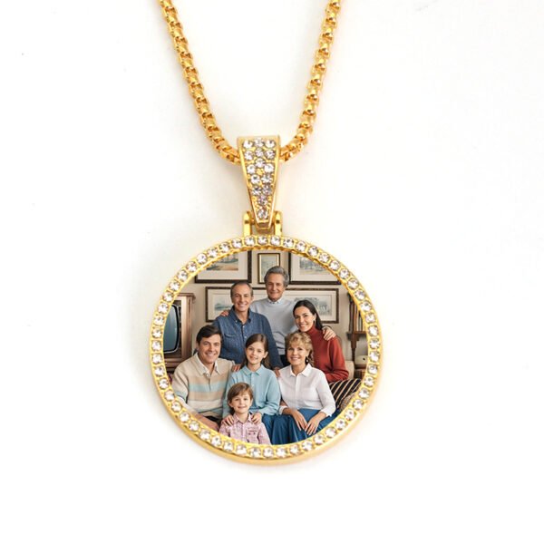 An isolated front view of a finished 18K gold plated stainless steel round picture necklace with a pave rhinestone bezel custom sublimated with a family photo.