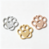 Three blank mirror polished stainless steel animal paw print pendants arranged in a triangular layout in silver, gold, and rose gold for B2B supplier.