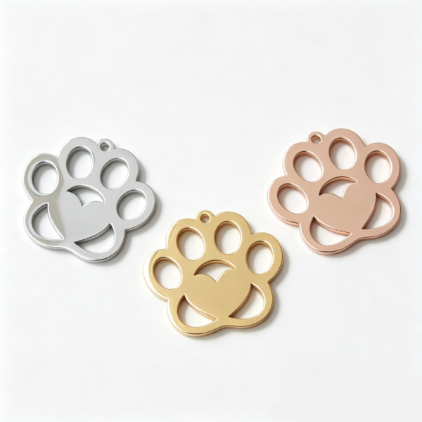 Three blank mirror polished stainless steel animal paw print pendants arranged in a triangular layout in silver, gold, and rose gold for B2B supplier.