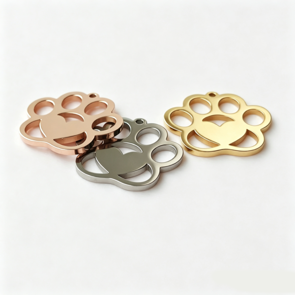 A bundle of wholesale custom silver and gold stainless steel dog paw blanks stacked neatly together to showcase the cut-out precision.