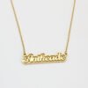 描边项链耳环套装_0006_图层 1 An isolated view of a single finished 18K gold plated stainless steel 2-layer cursive letter nameplate chain necklace on a clean white background.
