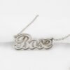 描边项链耳环套装_0009_IMG_6054 Macro close-up view of a finished silver stainless steel 3D layered cursive name pendant "Bose" to showcase the smooth laser-cut edges and high mirror polish.