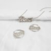 描边项链耳环套装_0010_图层 7 An isolated view of a wholesale finished silver stainless steel custom name jewelry set showing a 3D 2-layer nameplate necklace and matching hoop earrings with the text "Bose".