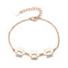A minimalist rose gold-plated stainless steel bracelet with a mirror-polished finish, featuring three interconnected paw-print charms and a secure lobster clasp.