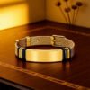 Men's ID bracelet with an all-gold stainless steel watch-style band, placed on a brown table.