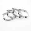 网手环 腐蚀抹油DAD_0003_图层 3 Three finished stainless steel Milanese loop name bracelets arranged in a closed loop coil layout on a clean backdrop for volume wholesale sourcing.