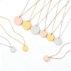 解释图片 (1) Technical production catalog photo showing wholesale blank round metal stamping tag necklaces in multi-size options across gold, silver, and rose gold finishes.