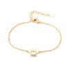 A minimalist gold-tone stainless steel bracelet with a mirror-polished finish, featuring a paw-print charm and a secure lobster clasp.